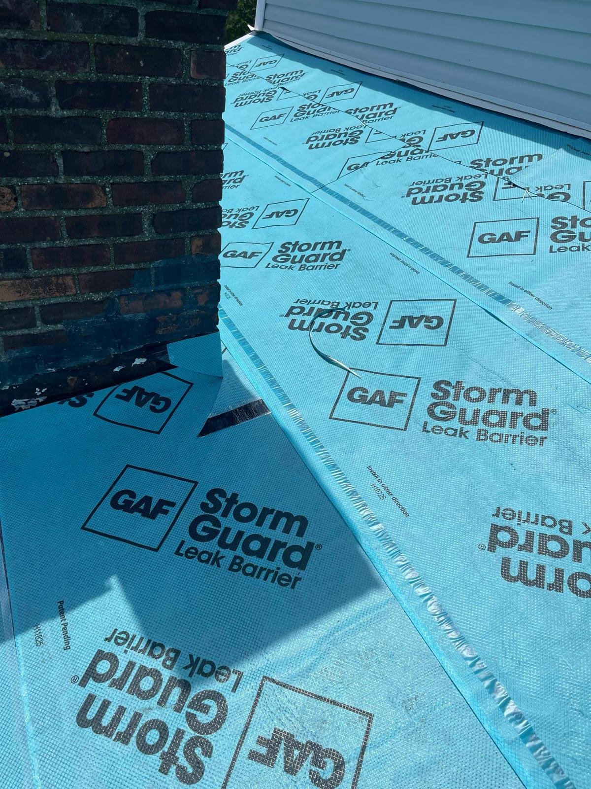 Chimney flashing preparation with GAF StormGuard underlayment in Babylon NY